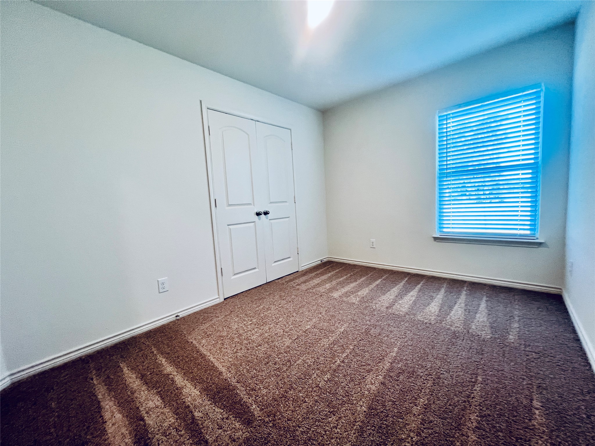 520 Locksley Cove Jarrell, TX 76537 - Photo 18 of 27 A well-lit, cozy bedroom offers comfortable carpeting and convenient closet access.