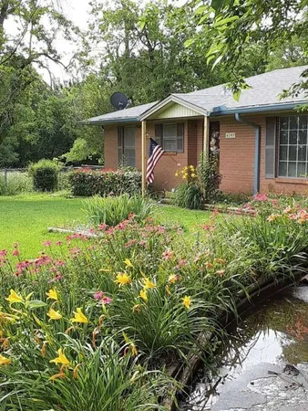 a front view of a house with garden
