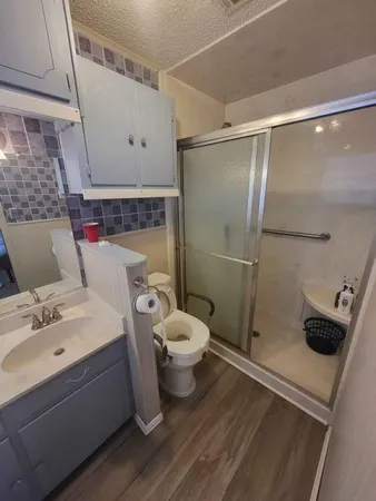 a bathroom with a sink toilet and shower