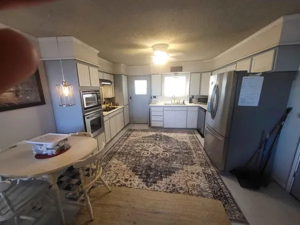 a kitchen with refrigerator and window
