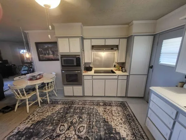 a kitchen with a sink stainless steel appliances and cabinets