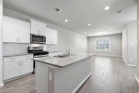 a kitchen with a sink microwave and stove
