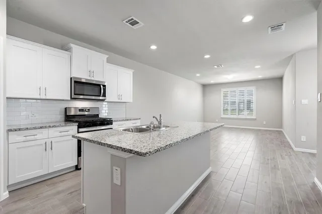 a kitchen with a sink microwave and stove