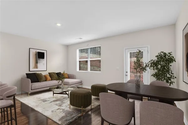 a living room with furniture potted plant and a window