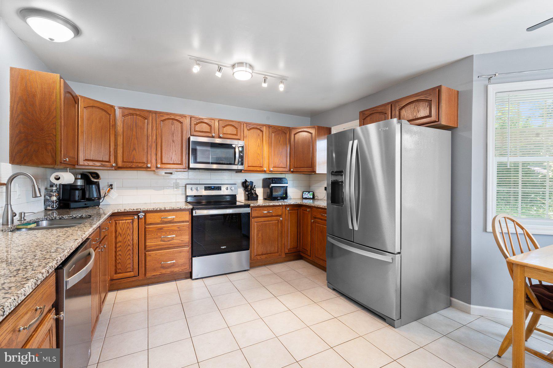 1903 Hain Road New Freedom, PA 17349 - Photo 14 of 40 a kitchen with granite countertop a refrigerator stove top oven a sink and dishwasher