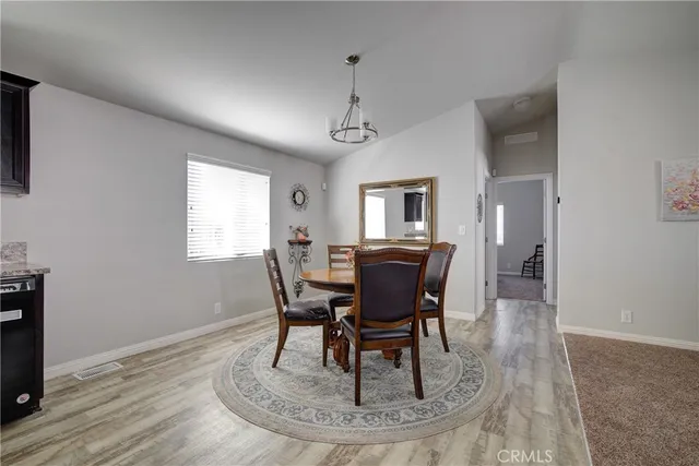 a dining room with wooden floor and breakfast area