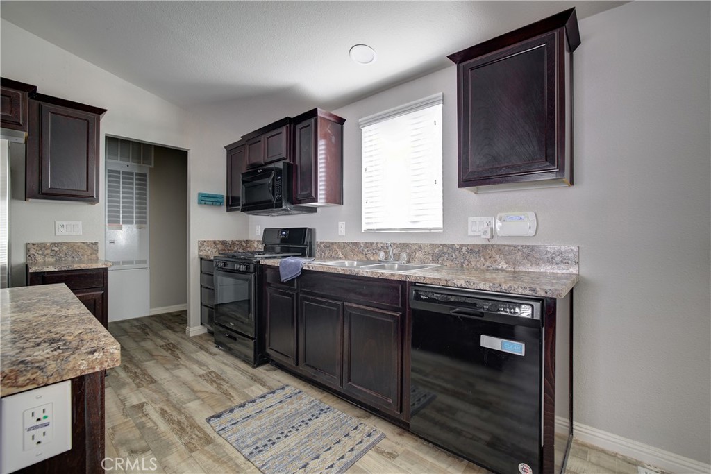 3700 Buchanan, Unit 25 Corona, CA 92503 - Photo 15 of 27 a kitchen with granite countertop cabinets stainless steel appliances and a counter space
