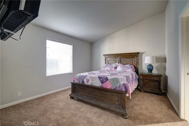 a bedroom with a bed and window