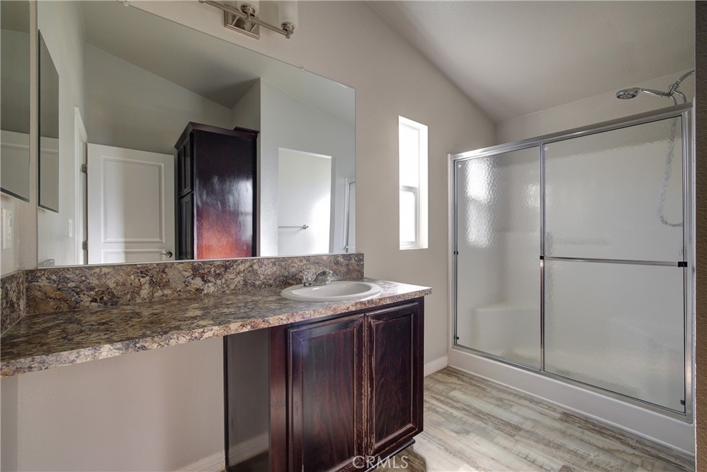 3700 Buchanan, Unit 25 Corona, CA 92503 - Photo 21 of 27 a bathroom with a granite countertop sink and a mirror