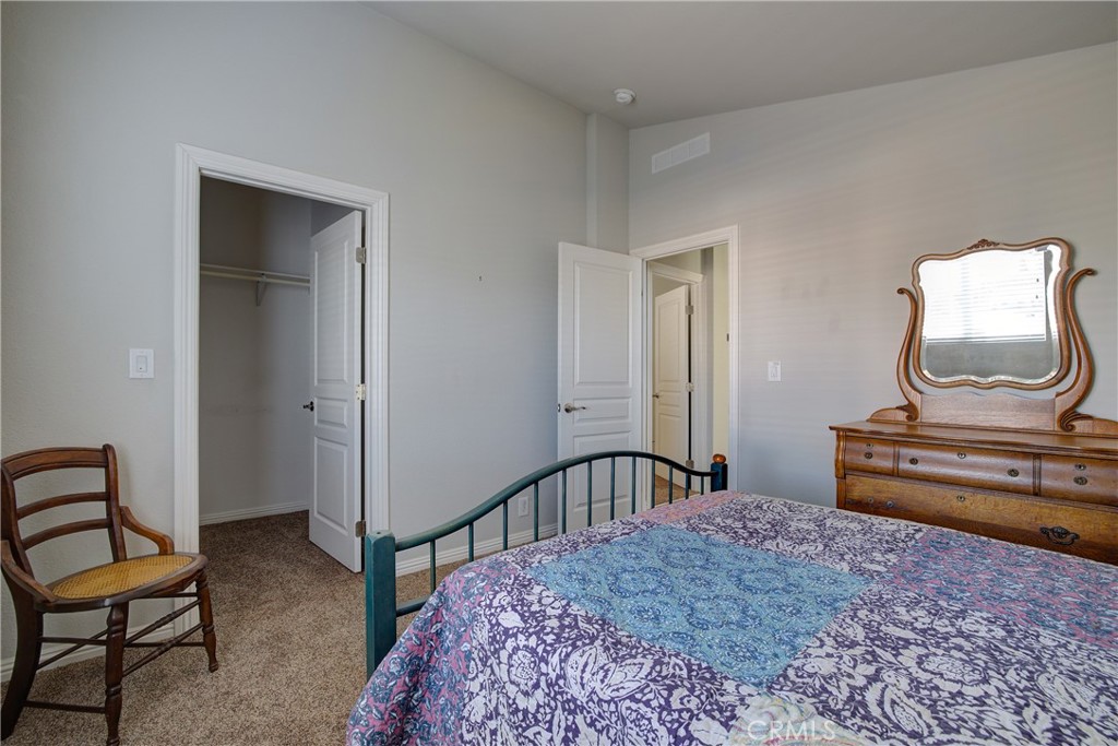3700 Buchanan, Unit 25 Corona, CA 92503 - Photo 23 of 27 a bedroom with a bed and cabinets