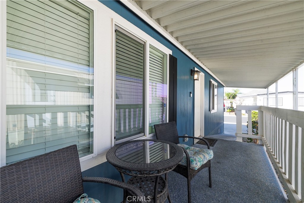 3700 Buchanan, Unit 25 Corona, CA 92503 - Photo 6 of 27 a balcony with furniture and wooden floor