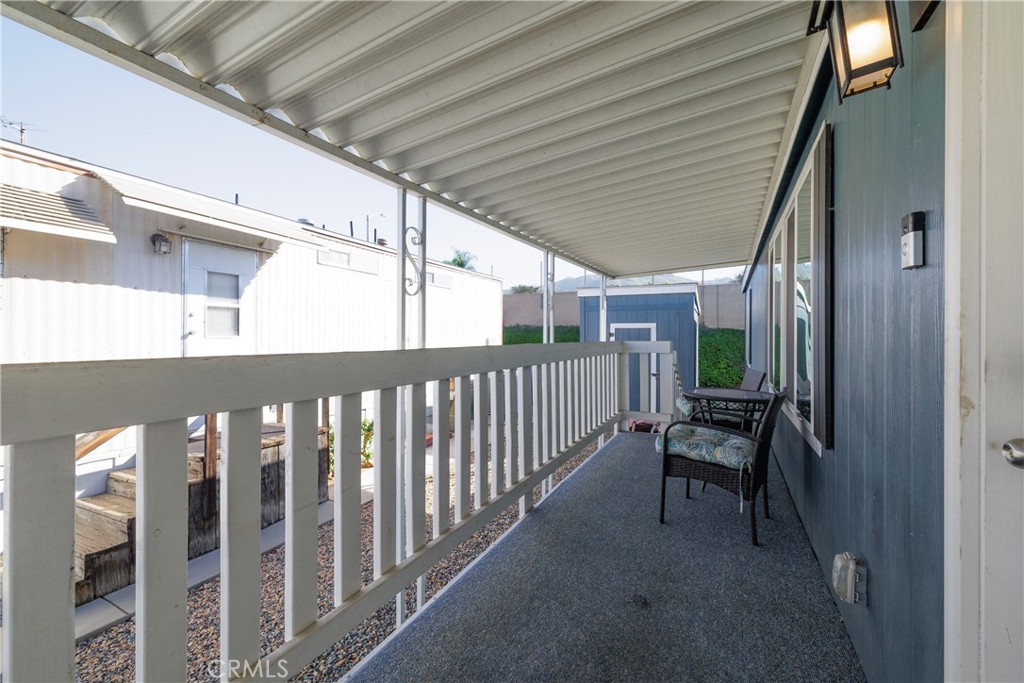 3700 Buchanan, Unit 25 Corona, CA 92503 - Photo 7 of 27 a porch with wooden floor outdoor seating and yard