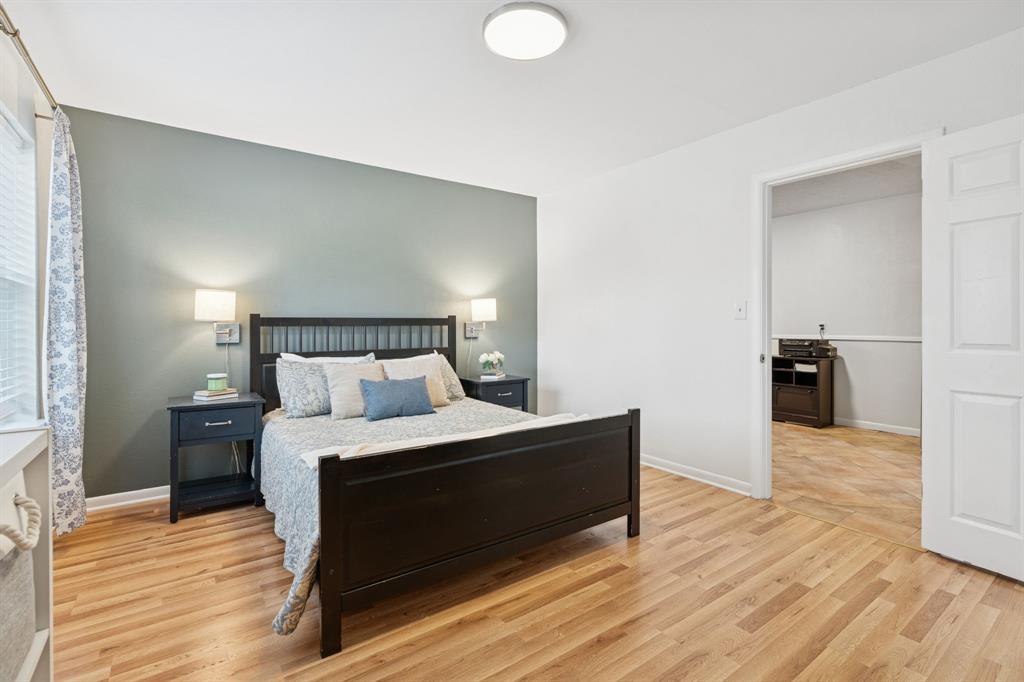 4001 Willow Bend Road Benbrook, TX 76116 - Photo 15 of 29 a bedroom with a bed and wooden floor