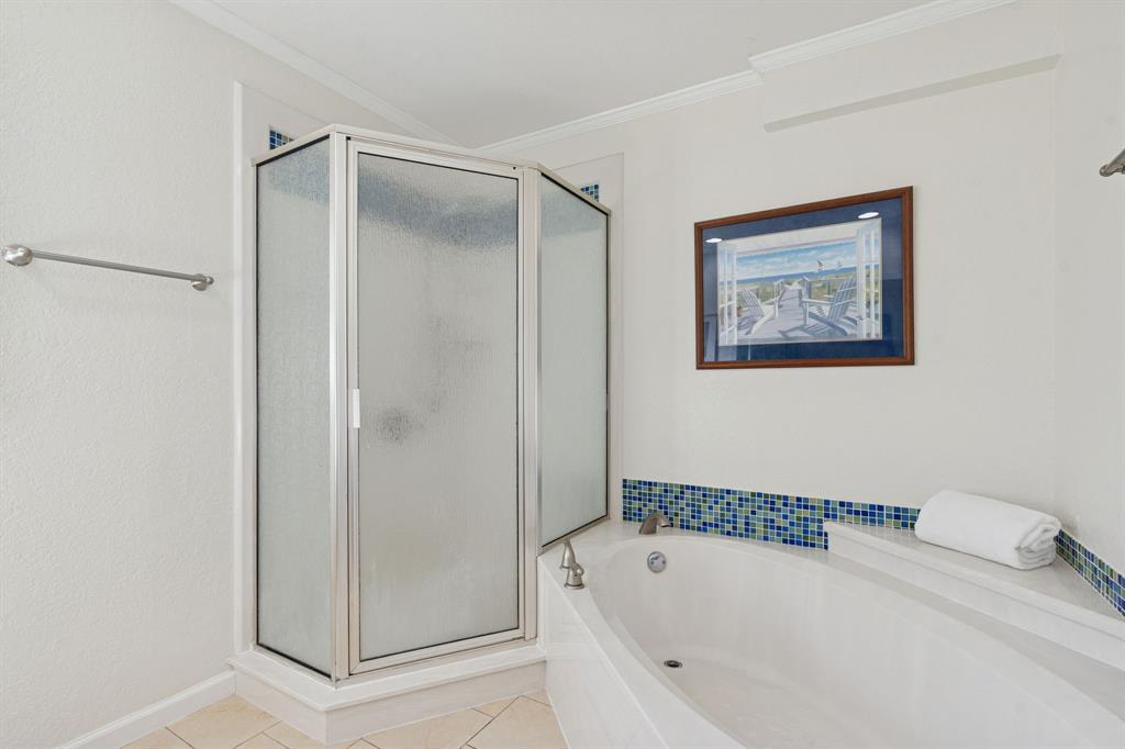 4001 Willow Bend Road Benbrook, TX 76116 - Photo 23 of 29 a bathroom with a bathtub and a shower