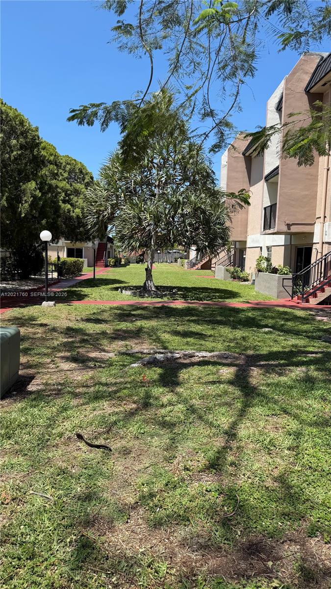 3901 Southwest 109th Avenue, Unit 4 Miami, FL 33165 - Photo 6 of 15 a swimming pool with outdoor seating and yard
