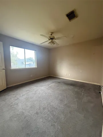 a view of a house with a big yard and large trees