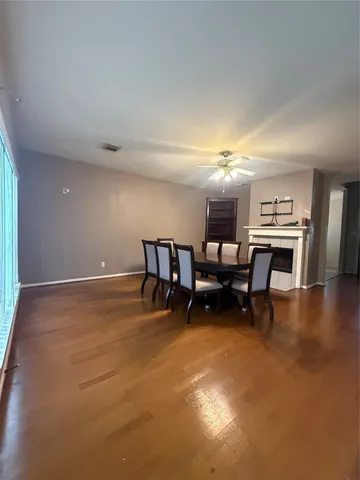 a large kitchen with a large counter top a sink a stove and a refrigerator