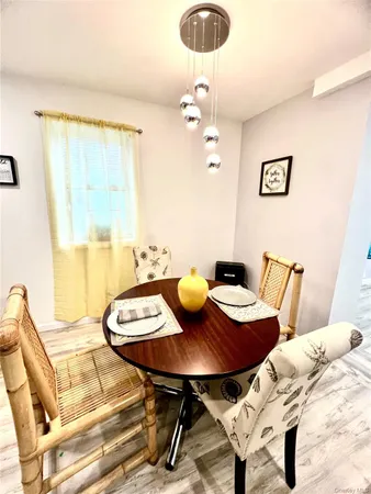 a view of a dining room with furniture and chandelier