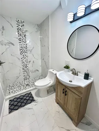 a bathroom with a sink a toilet and a mirror