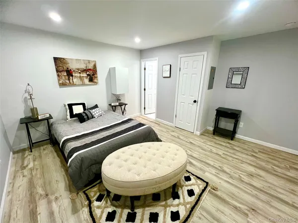 a bedroom with a bed and a view of kitchen