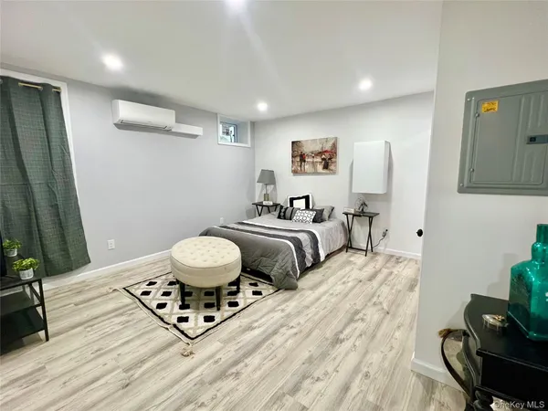 a bedroom with a bed and a chair in it