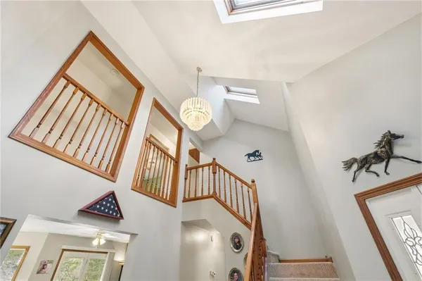 a view of staircase with railing and a rug