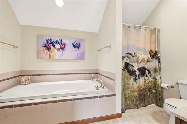 a spacious bathroom with a bathtub and toilet