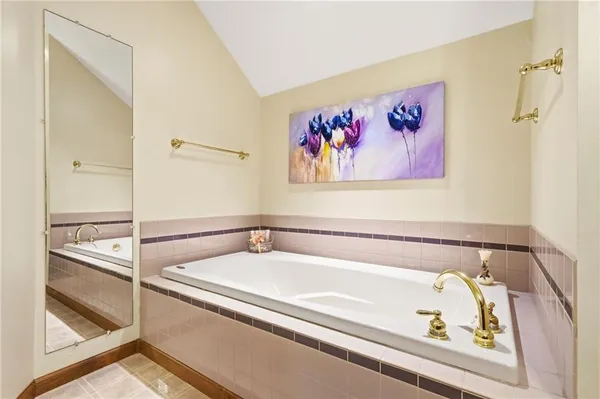 a bathroom with a bathtub and a shower