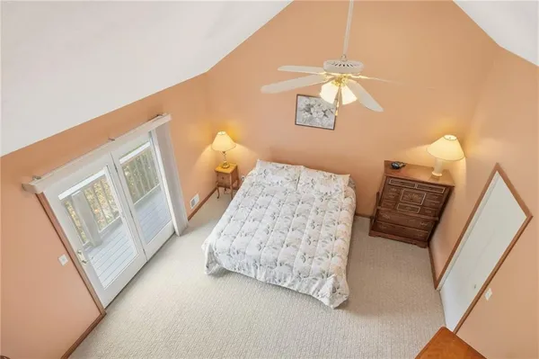 a bedroom with a bed and a mirror