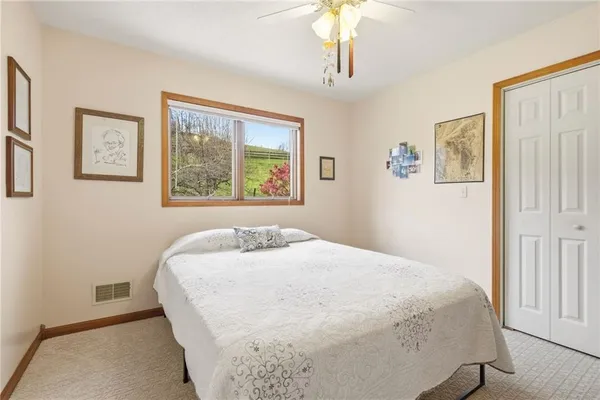a bedroom with a large bed and a chandelier
