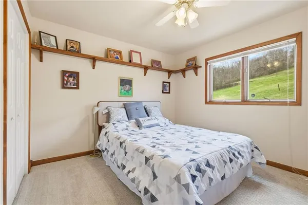 a bedroom with a large bed and a window