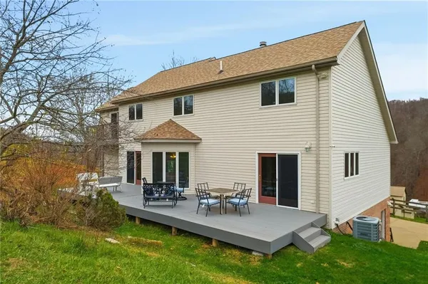 a view of a house with patio and a yard