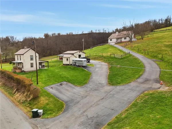 an aerial view of a house with outdoor space and a lake view