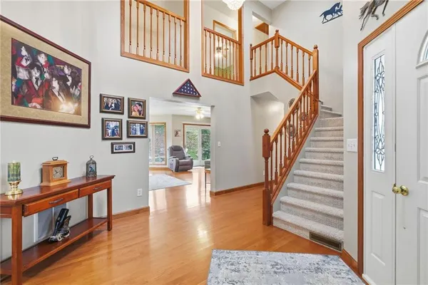 a view of entryway and hall with wooden floor