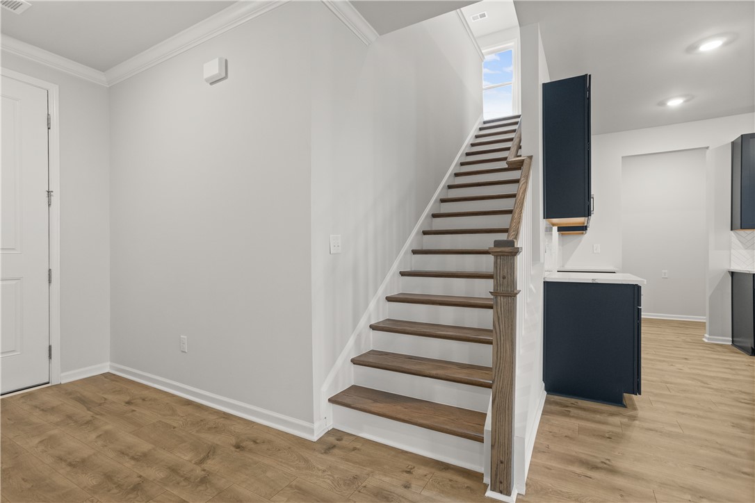 629 Sweetspire Trail, Unit 149 Seneca, SC 29678 - Photo 10 of 30 A striking modern staircase with rich wood treads and classic white risers leads to sun-filled upper levels.
