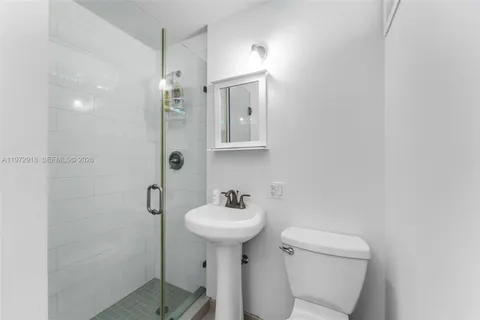 a bathroom with a sink a mirror and a toilet