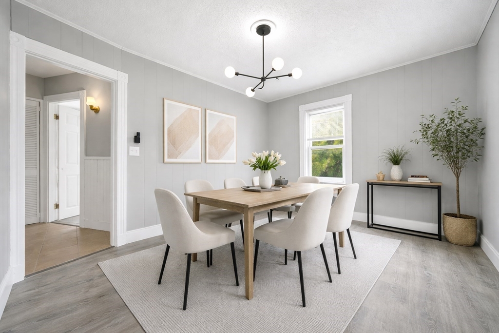29-31 Auburn Street, Unit 2L Everett, MA 02149 - Photo 1 of 18 a dining room with furniture potted plants and wooden floor