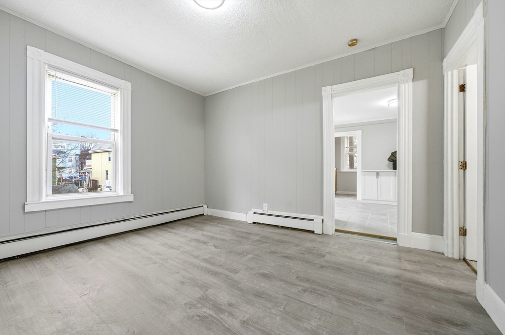 29-31 Auburn Street, Unit 2L Everett, MA 02149 - Photo 13 of 18 an empty room with windows and closet