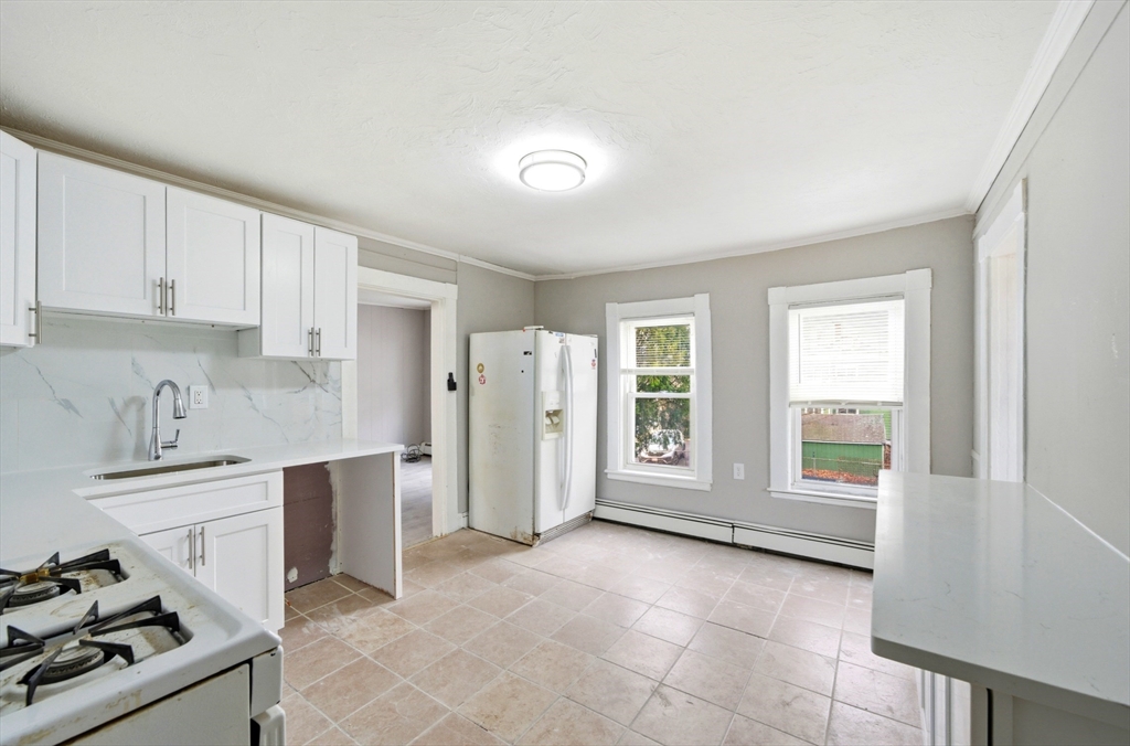 29-31 Auburn Street, Unit 2L Everett, MA 02149 - Photo 4 of 18 a view of a kitchen with an empty space and a window