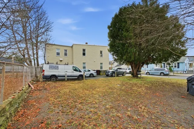 a view of a large house with a large tree in front of it