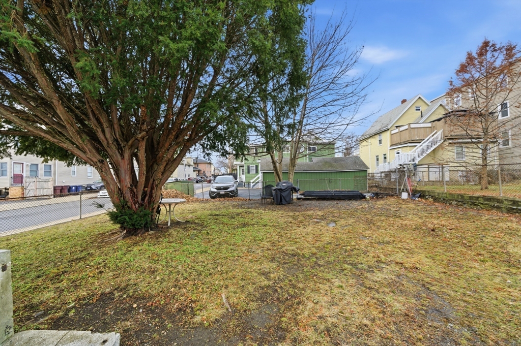 29-31 Auburn Street, Unit 2L Everett, MA 02149 - Photo 8 of 18 a small garden covered with tall trees