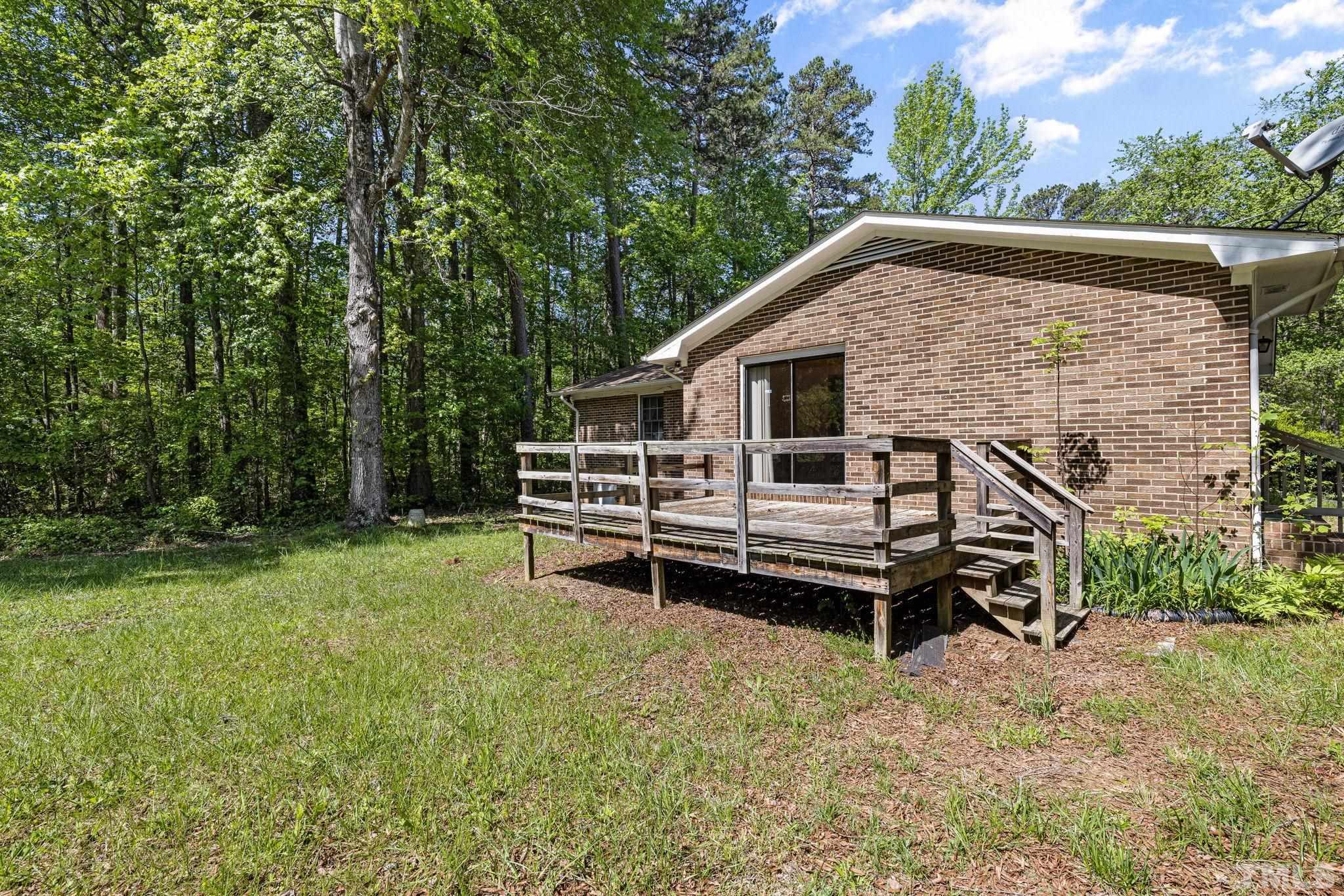 3509 Hurdle Mills Road Roxboro, NC 27574 - Photo 29 of 30 a view of a house with a yard and sitting area