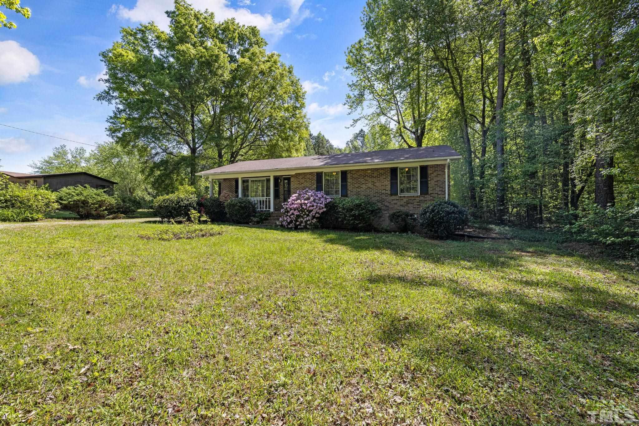 3509 Hurdle Mills Road Roxboro, NC 27574 - Photo 4 of 30 a view of house with yard and outdoor seating