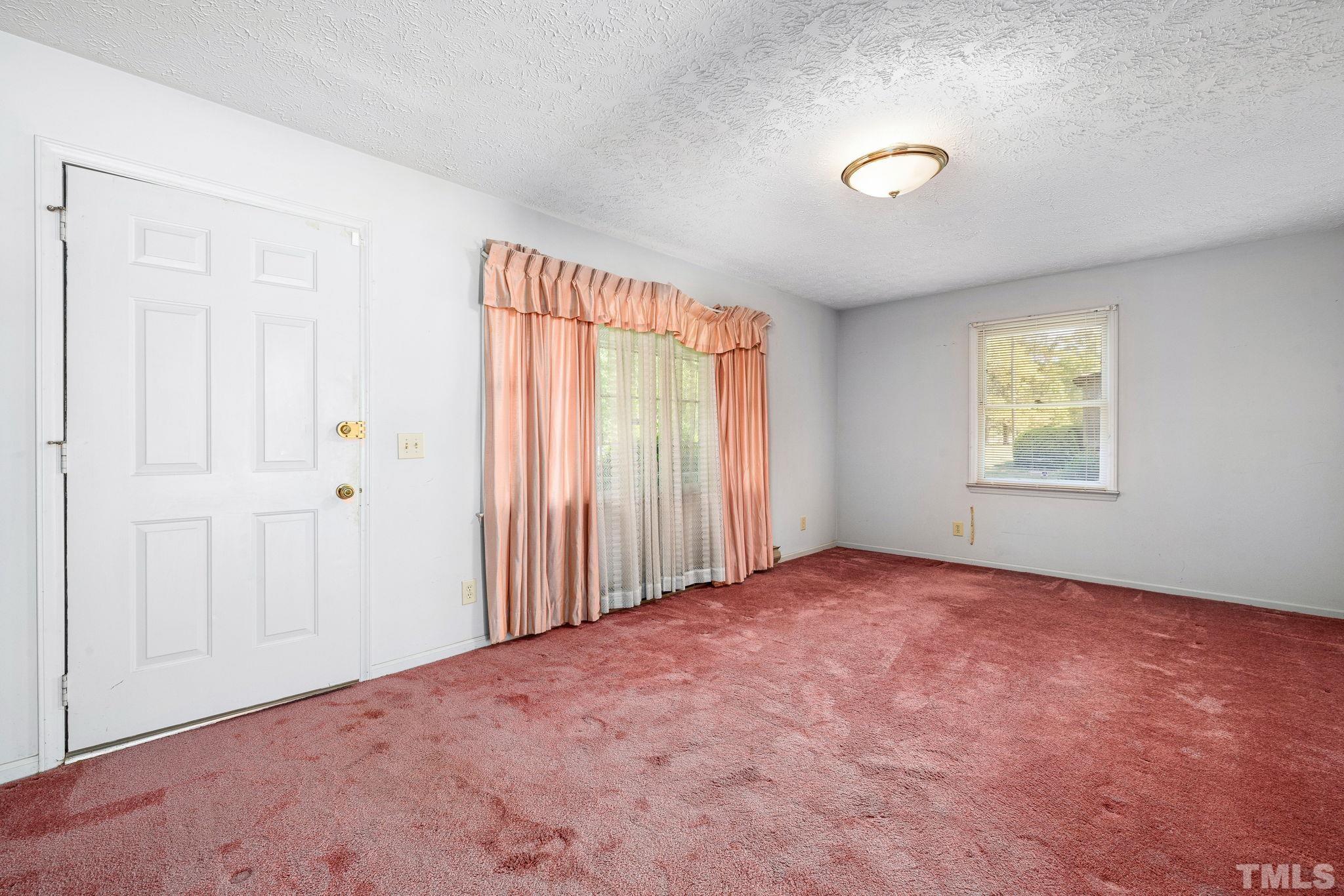 3509 Hurdle Mills Road Roxboro, NC 27574 - Photo 7 of 30 an empty room with windows and closet