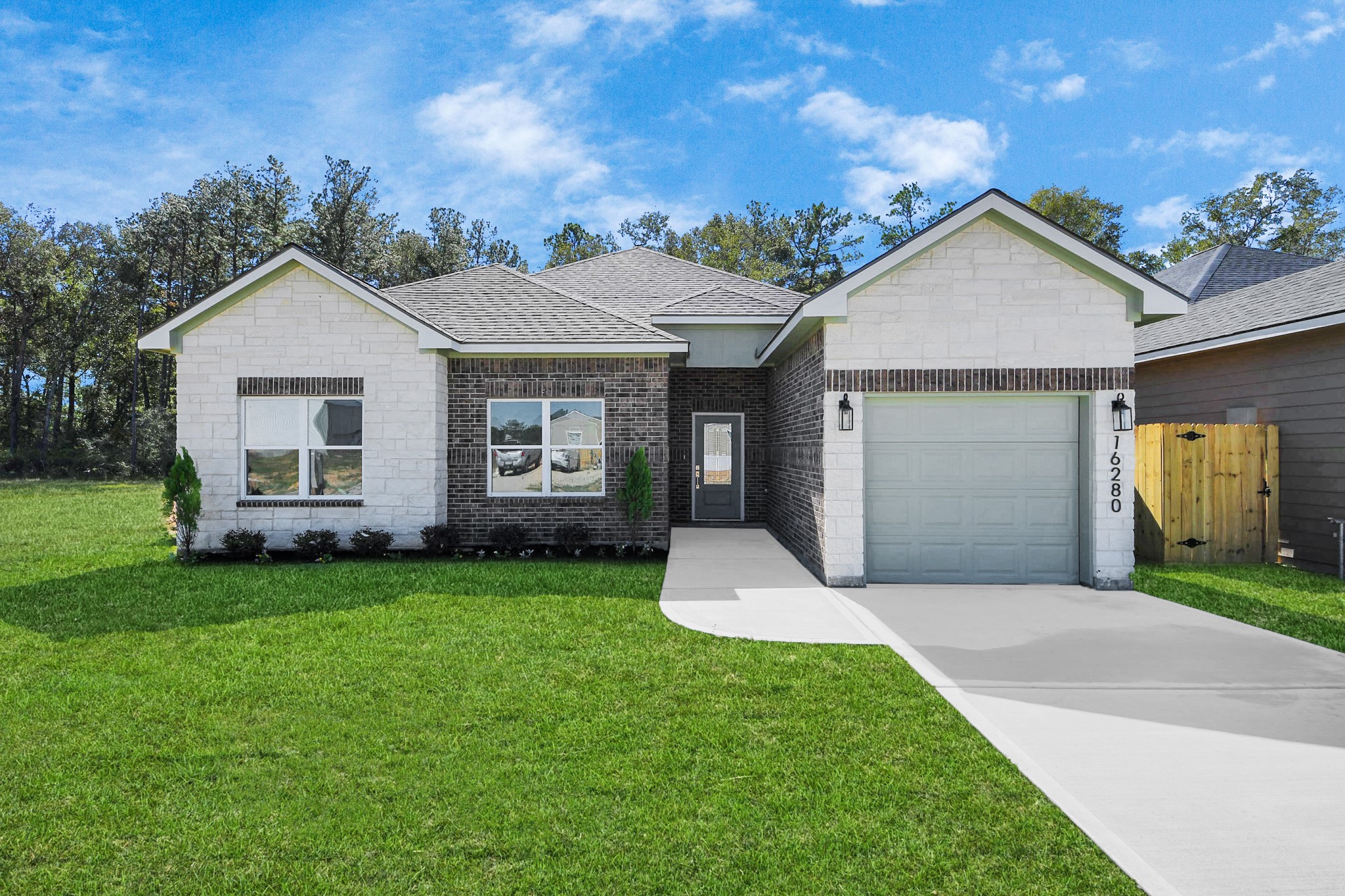 a view of a house with a yard and garage