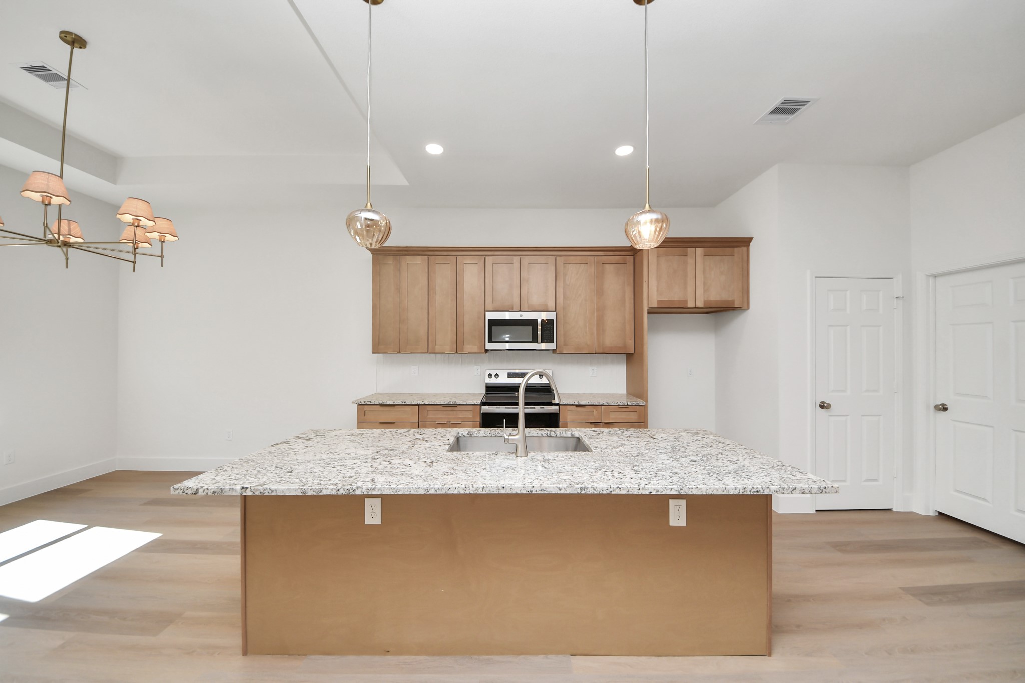 16280 Jeet Street Conroe, TX 77306 - Photo 12 of 44 a kitchen with kitchen island granite countertop a sink a counter top space appliances and cabinets