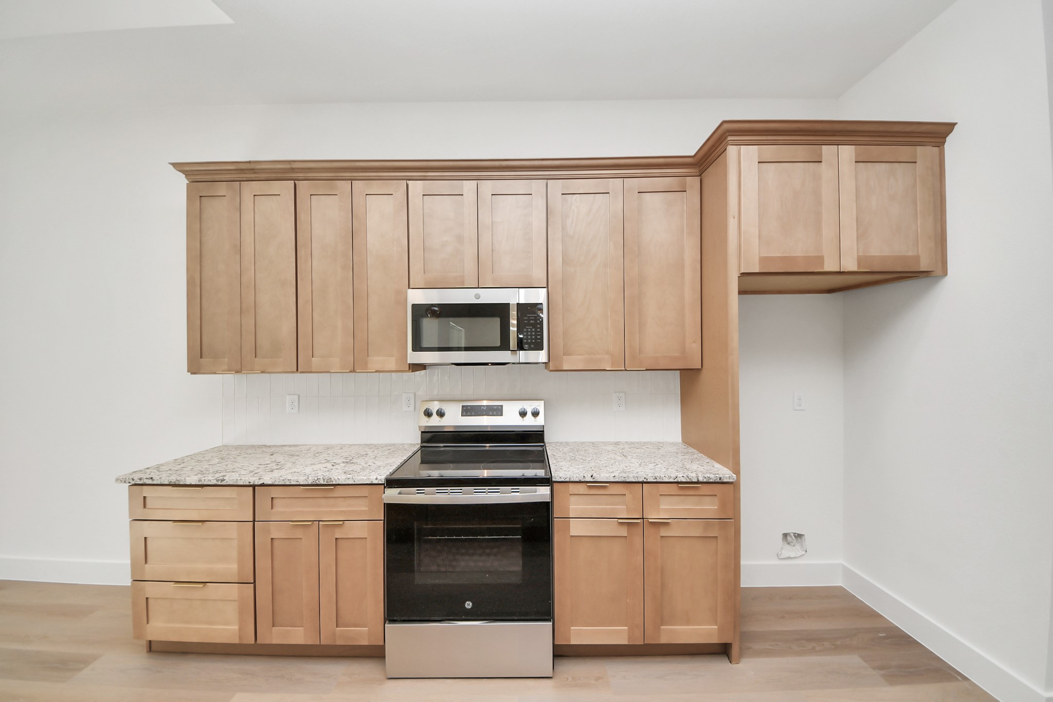 16280 Jeet Street Conroe, TX 77306 - Photo 13 of 44 a kitchen with stainless steel appliances granite countertop a stove a microwave and a refrigerator