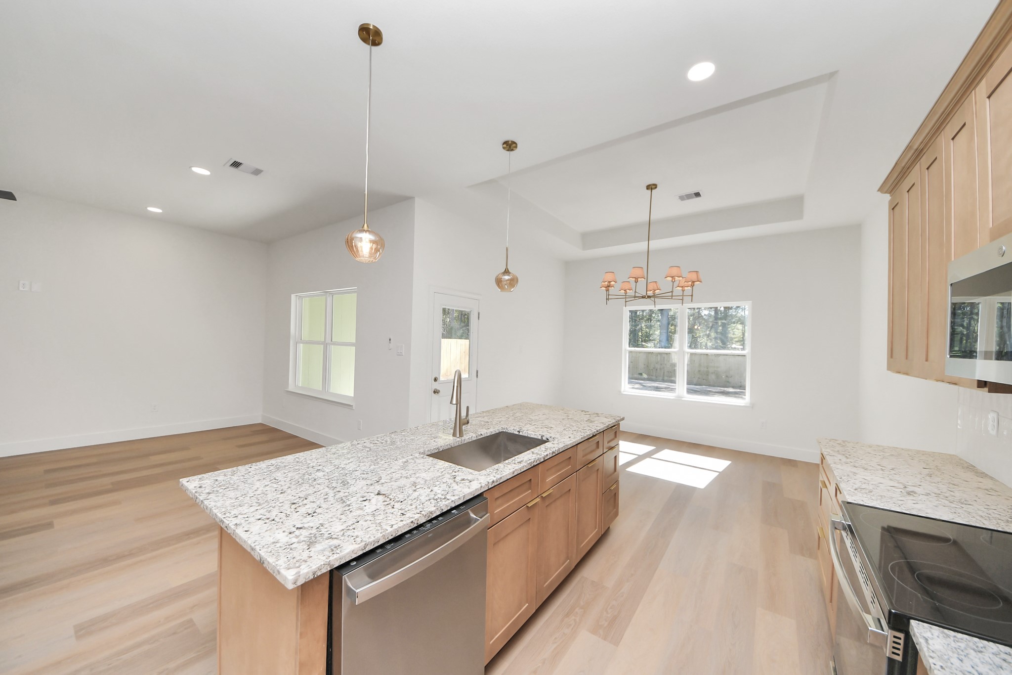 16280 Jeet Street Conroe, TX 77306 - Photo 17 of 44 a large kitchen with kitchen island a sink stainless steel appliances and a counter space