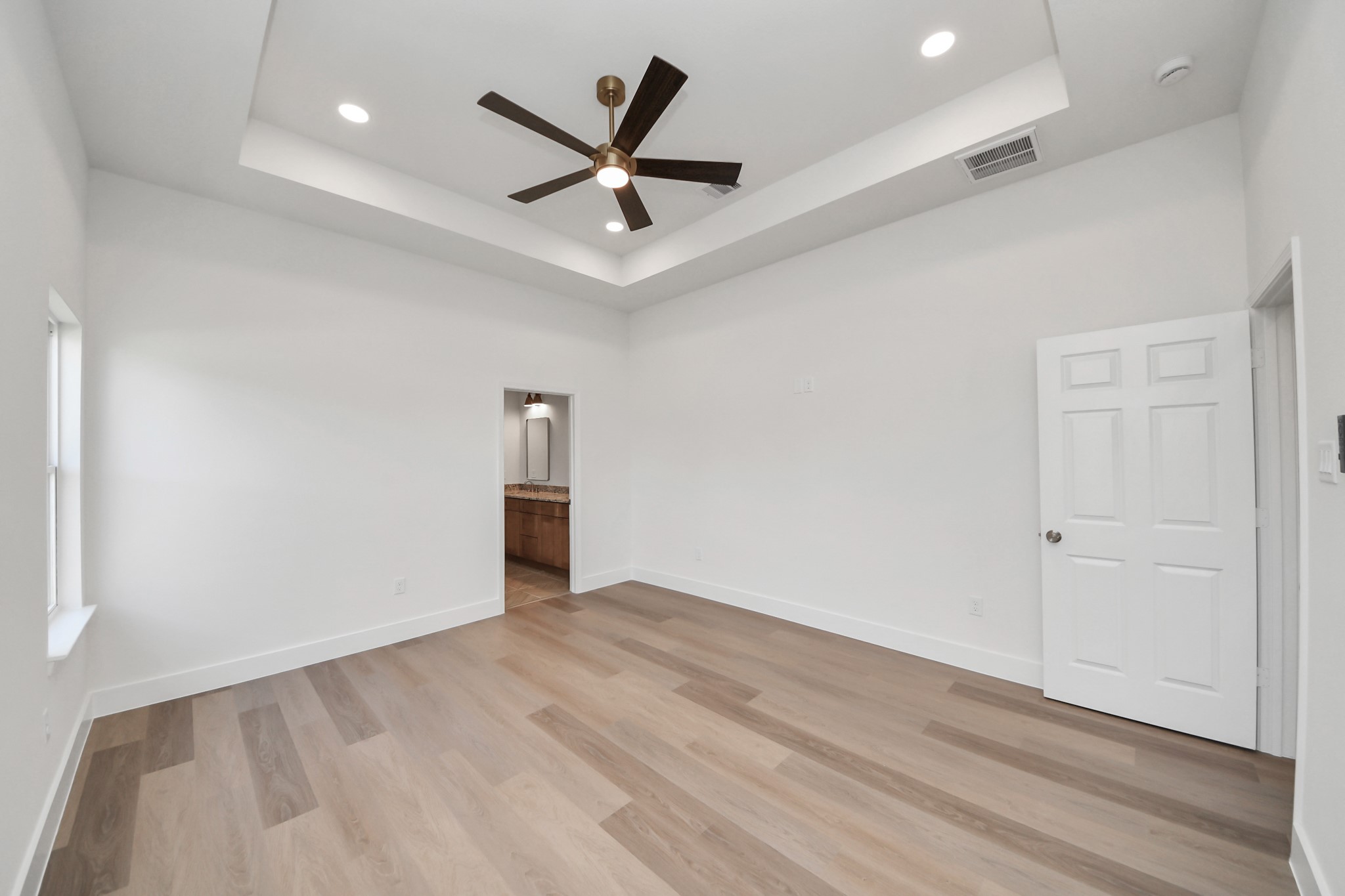 16280 Jeet Street Conroe, TX 77306 - Photo 25 of 44 an empty room with wooden floor and ceiling fan