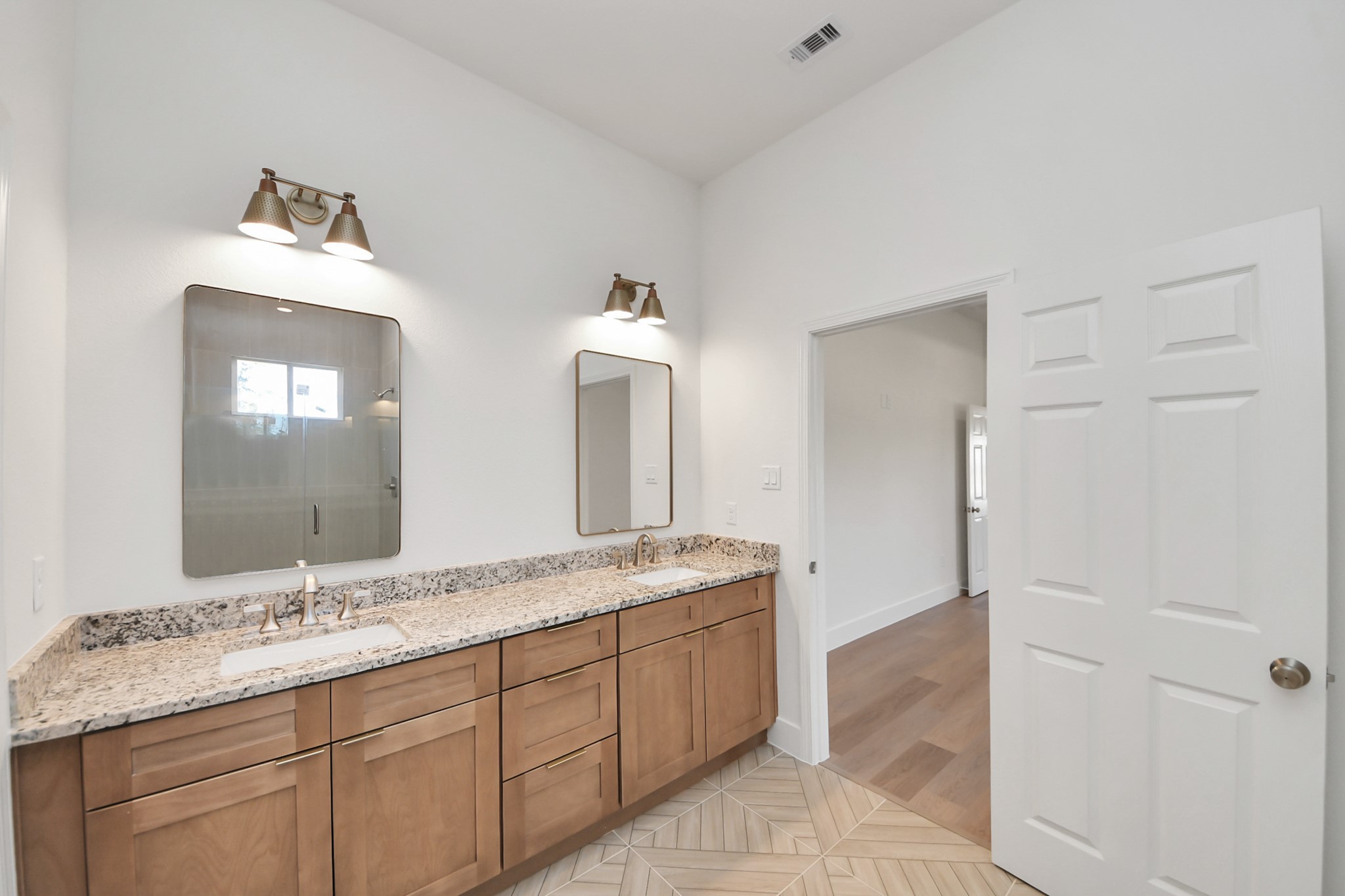 16280 Jeet Street Conroe, TX 77306 - Photo 29 of 44 a spacious bathroom with a granite countertop sink and a mirror